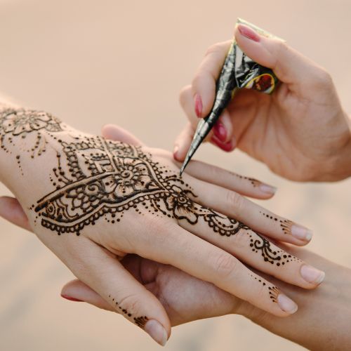 Henna being applied on clients hand at Kally's Studio Federal Way