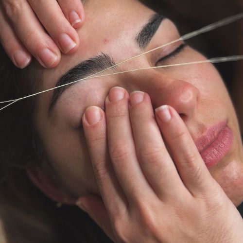 Technician performing eyebrow threading in Silverdale at a Kally Threading salon